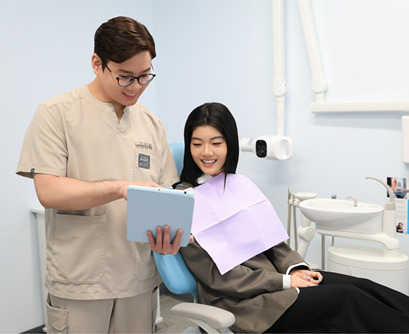 Dentist showing patient a tablet