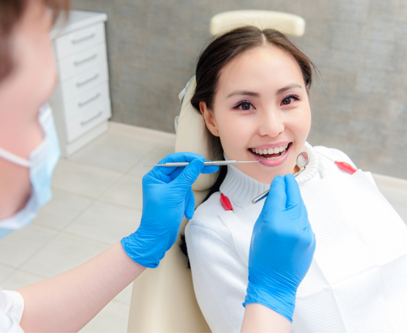 Woman having her teeth examined by a dentist