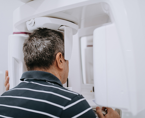 Man having mouth scanned with cone beam scanner