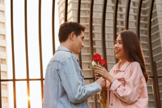 Patient with good dental health giving flowers to date