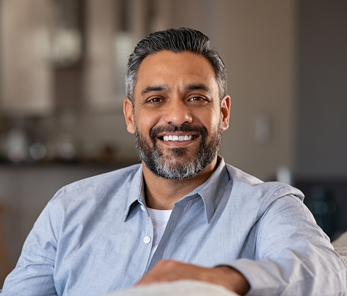Man sitting on couch smiling
