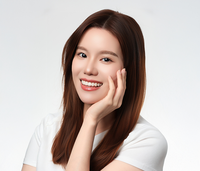 Woman smiling and rubbing her cheek