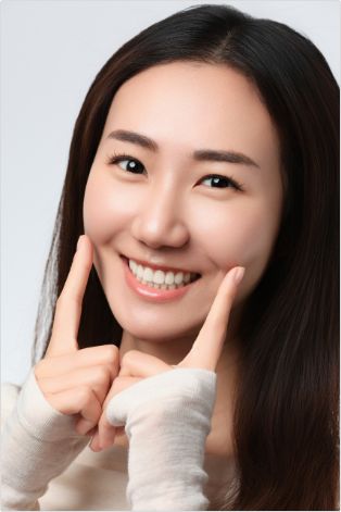 Female patient pointing to her smile