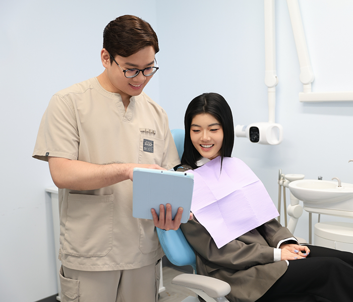 Dr. Chang showing patient a tablet